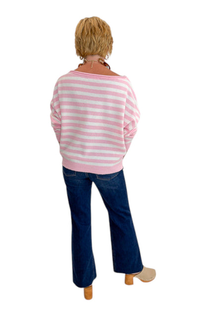 Back view of woman wearing Swagger Boutique’s Pink &amp; White Striped Sweater with jeans against white studio background.