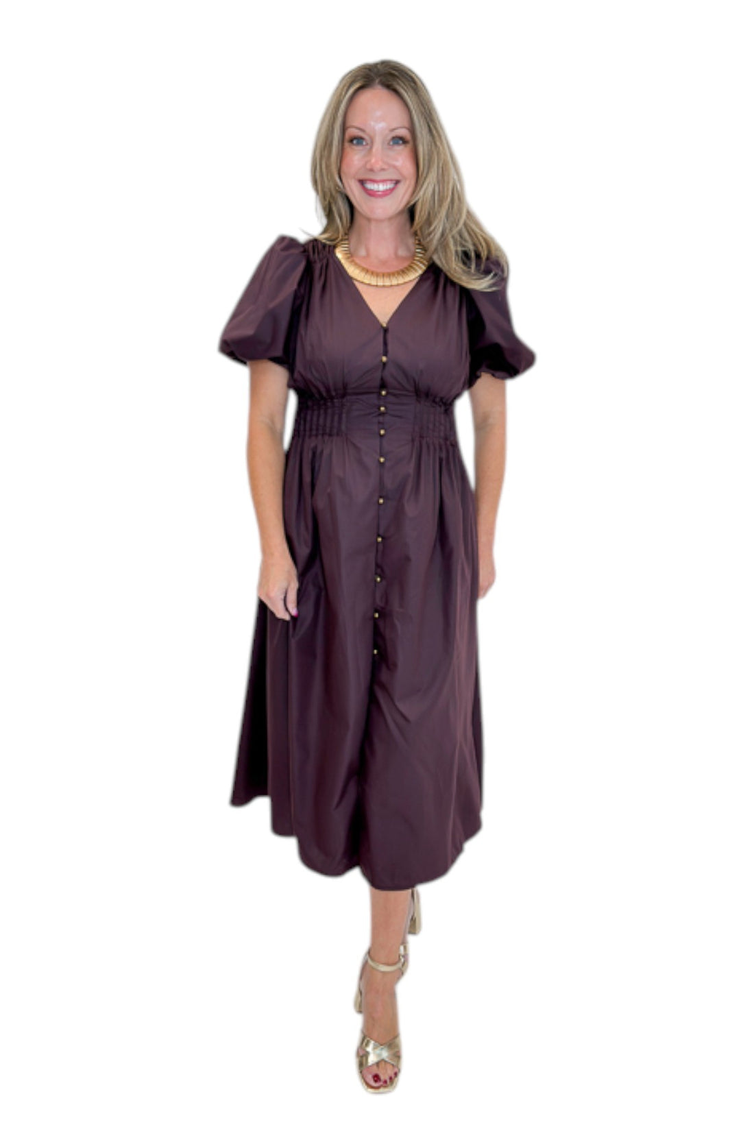 Front view of woman wearing Swagger Boutique’s Plum Pleated Waist Midi Dress by Entro with heels against white studio background.
