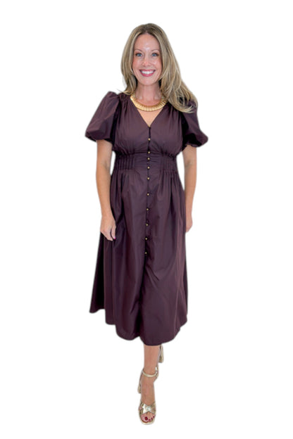 Front view of woman wearing Swagger Boutique’s Plum Pleated Waist Midi Dress by Entro with heels against white studio background.