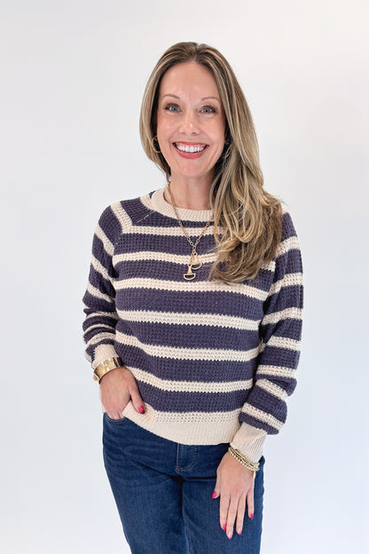 Front view of woman wearing Swagger Boutique’s Plum Striped Waffle Weave Sweater with jeans against white studio background.