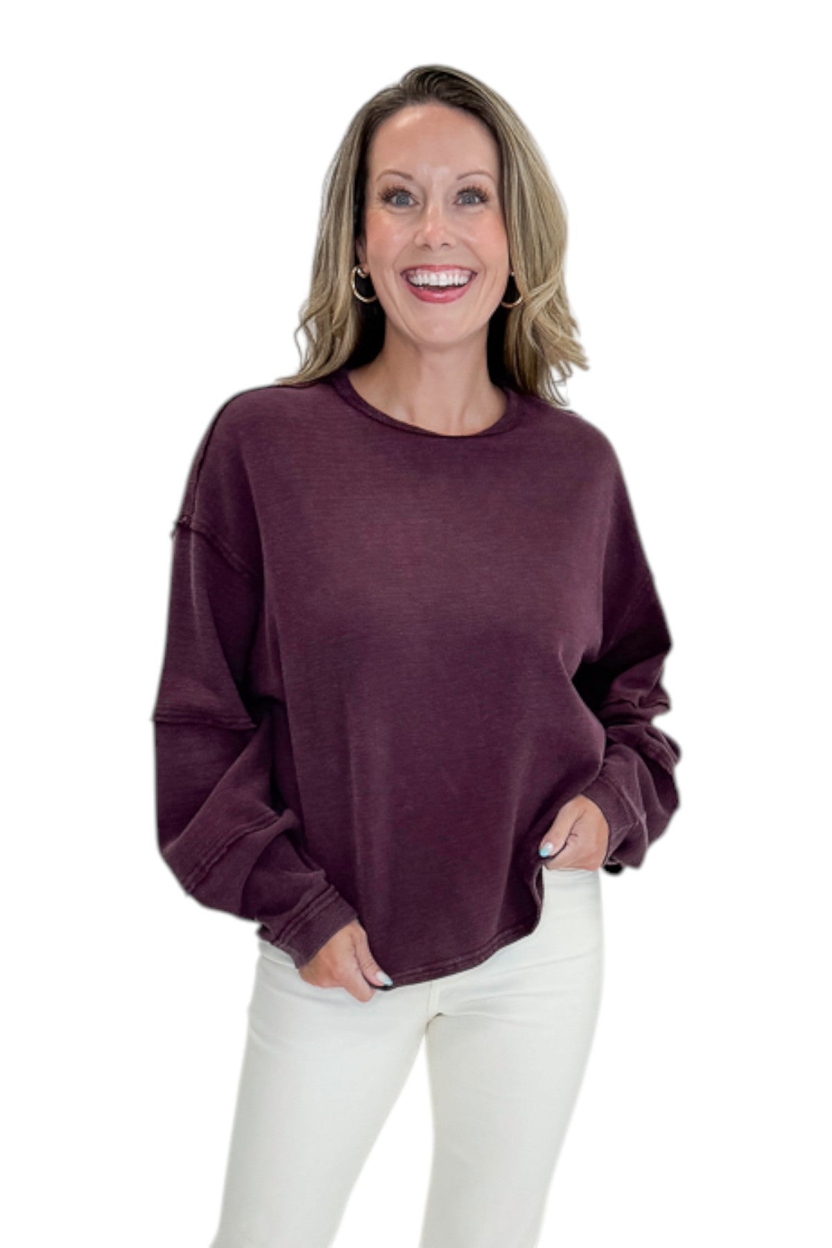 Front view of woman wearing Swagger Boutique’s Plum Textured Sweatshirt with jeans against white studio background.