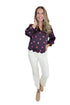 Front view of woman wearing Swagger Boutique’s Plum & Pink Polka Dot 3/4 Sleeve Top by Entro with jeans against white studio background.