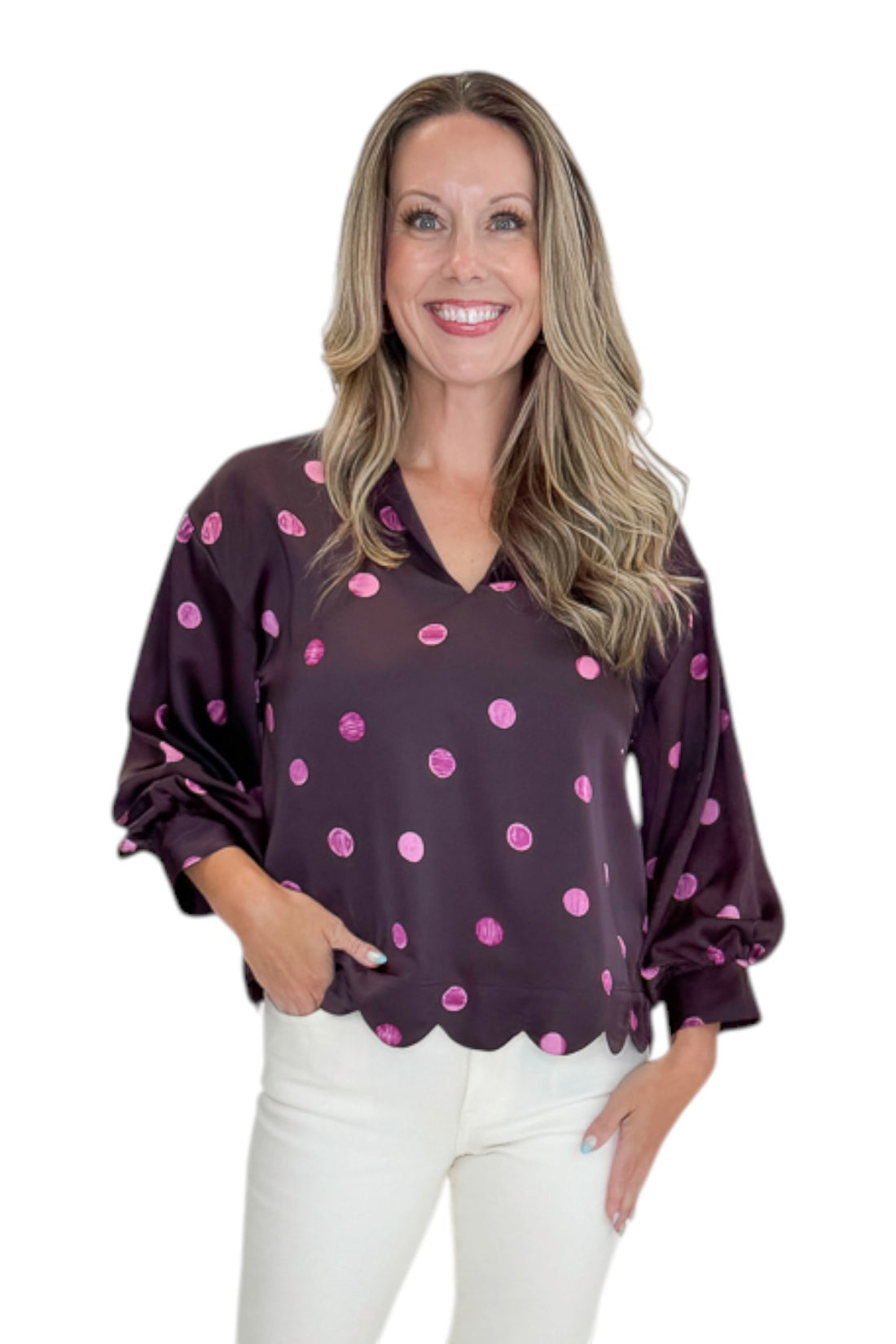 Front view of woman wearing Swagger Boutique’s Plum &amp; Pink Polka Dot 3/4 Sleeve Top by Entro with jeans against white studio background.