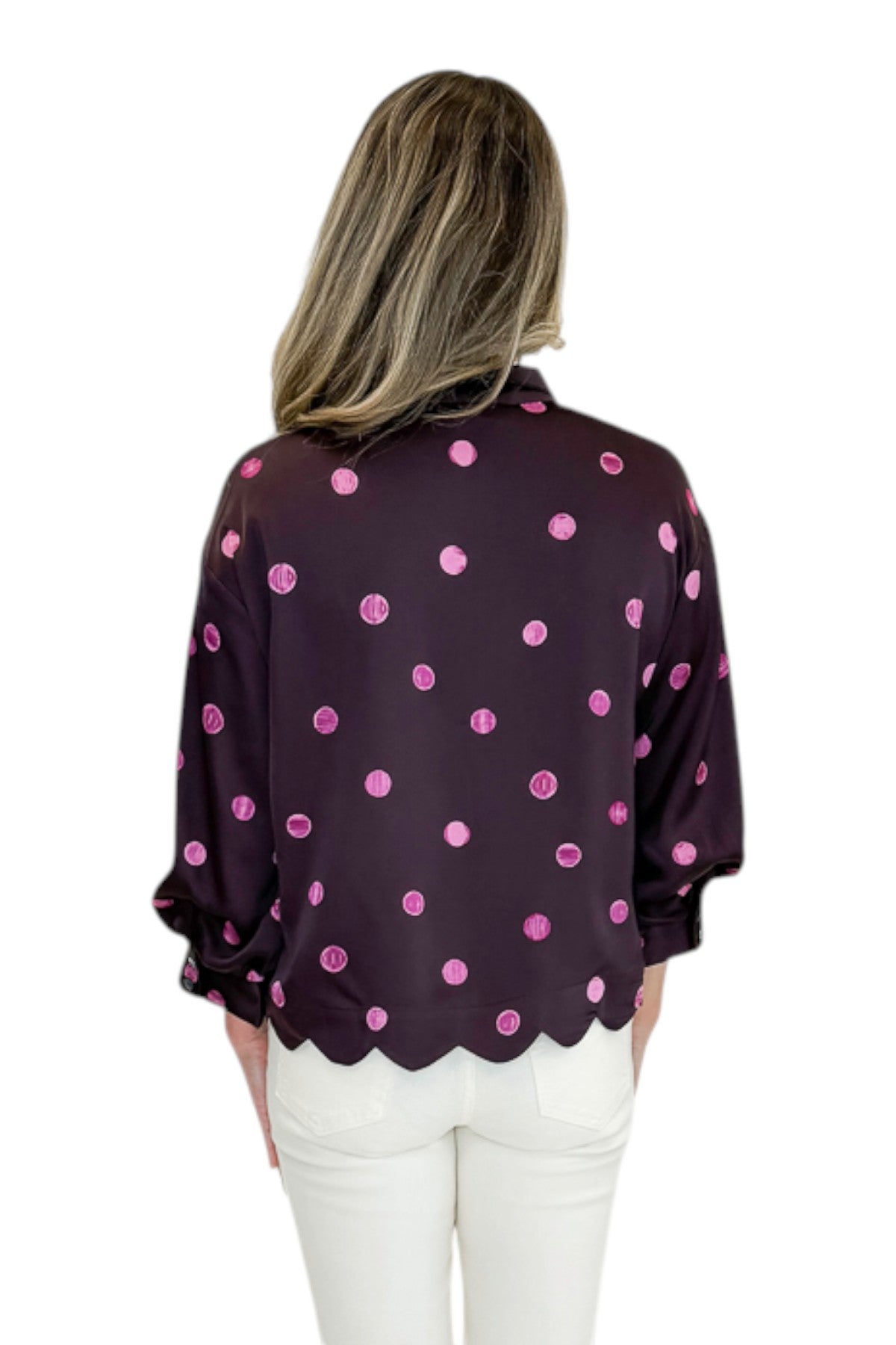 Back view of woman wearing Swagger Boutique’s Plum &amp; Pink Polka Dot 3/4 Sleeve Top by Entro with jeans against white studio background.