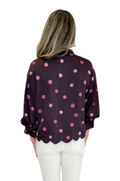Back view of woman wearing Swagger Boutique’s Plum &amp; Pink Polka Dot 3/4 Sleeve Top by Entro with jeans against white studio background.