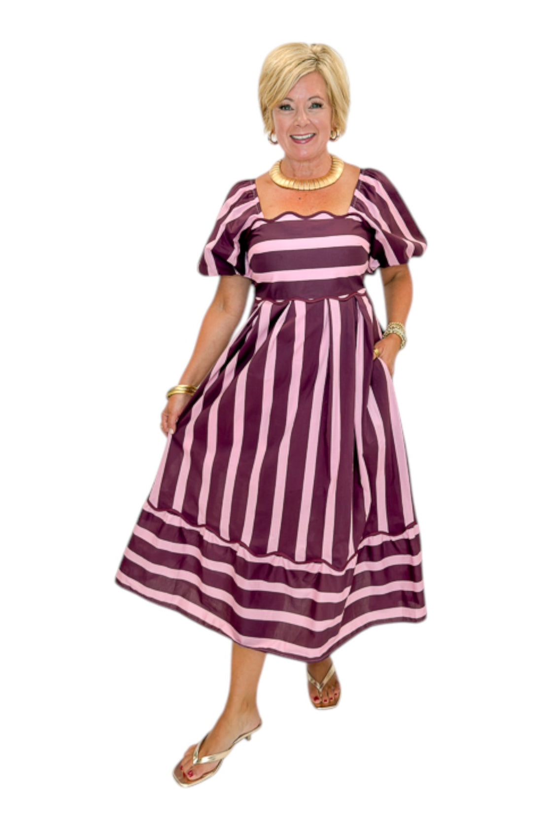 Front view of woman wearing Swagger Boutique’s Plum &amp; Pink Striped Midi Dress by Entro with sandals against white studio background.