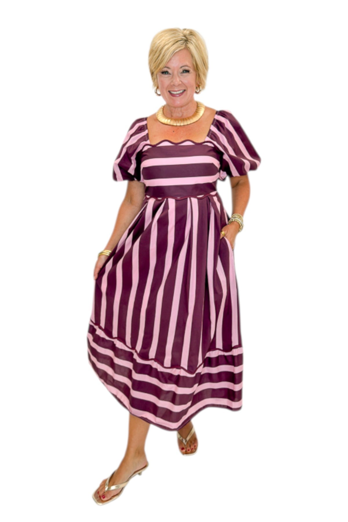 Front view of woman wearing Swagger Boutique’s Plum &amp; Pink Striped Midi Dress by Entro with sandals against white studio background.