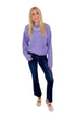 Front view of woman wearing Swagger Boutique’s Purple Ribbed sweater with jeans against white studio background.