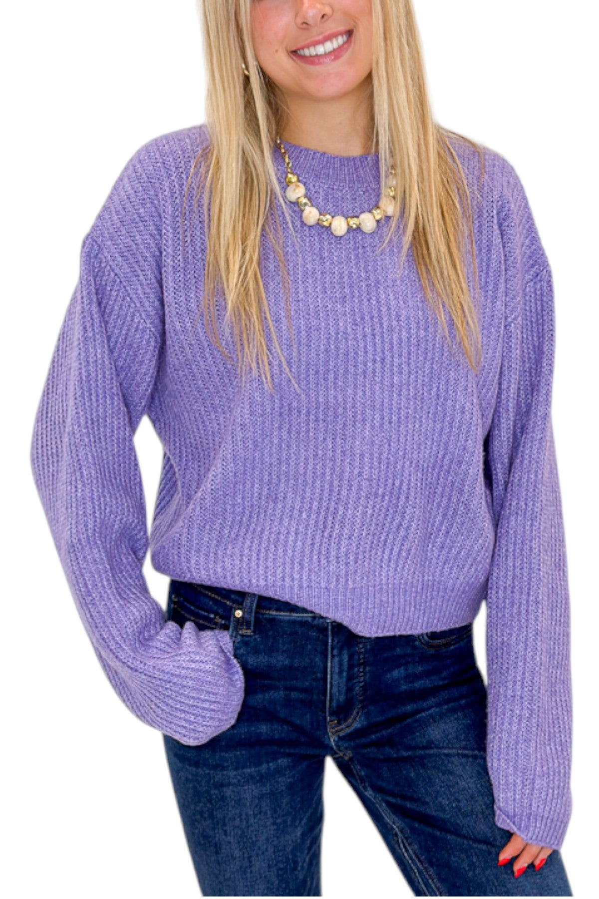 Front detail view of woman wearing Swagger Boutique’s Purple Ribbed sweater with jeans against white studio background.