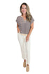 Front view of woman wearing Swagger Boutique’s Purple & Beige Striped Sleeveless Sweater with jeans against white studio background.