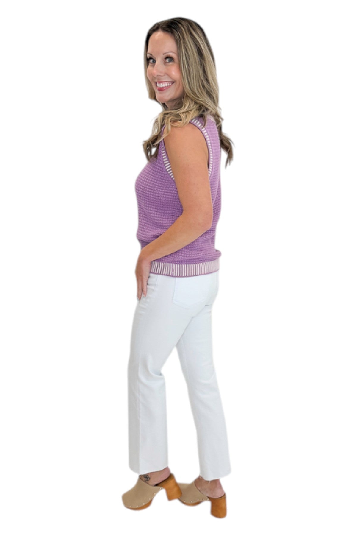 Side view of woman wearing Swagger Boutique’s Purple &amp; White Textured Sweater Tank with jeans against white studio background.