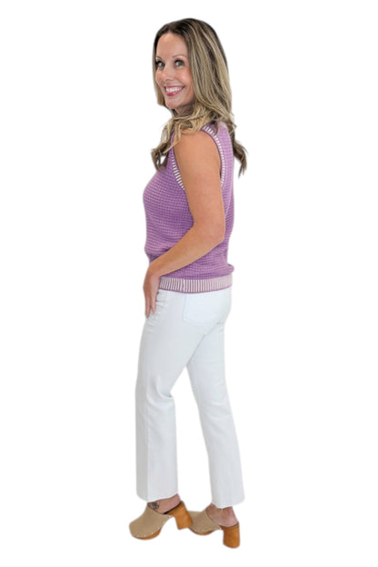 Side view of woman wearing Swagger Boutique’s Purple &amp; White Textured Sweater Tank with jeans against white studio background.