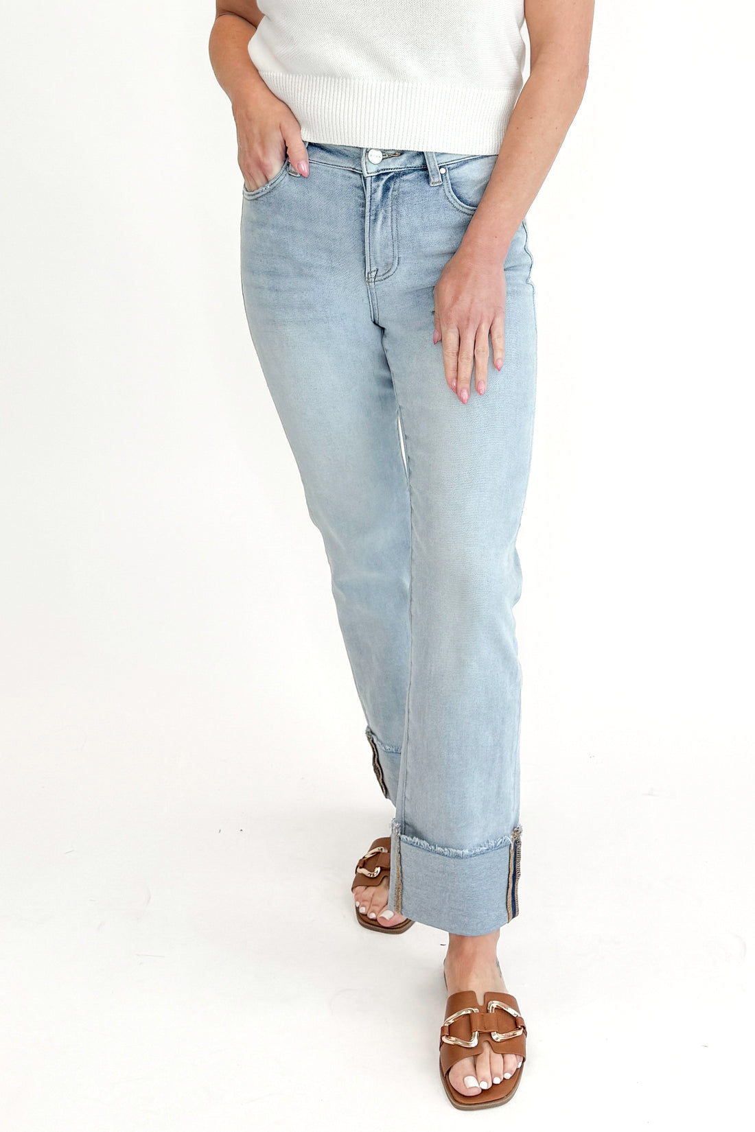 Front view of woman wearing sweater with Light Wash Relaxed Straight Jeans by Risen against white studio background. 