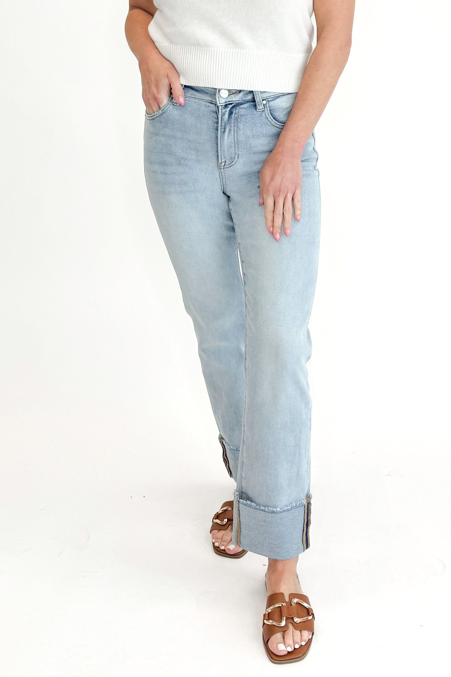 Front view of woman wearing sweater with Light Wash Relaxed Straight Jeans by Risen against white studio background. 