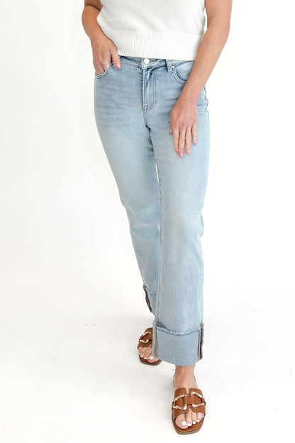 Front view of woman wearing sweater with Light Wash Relaxed Straight Jeans by Risen against white studio background. 
