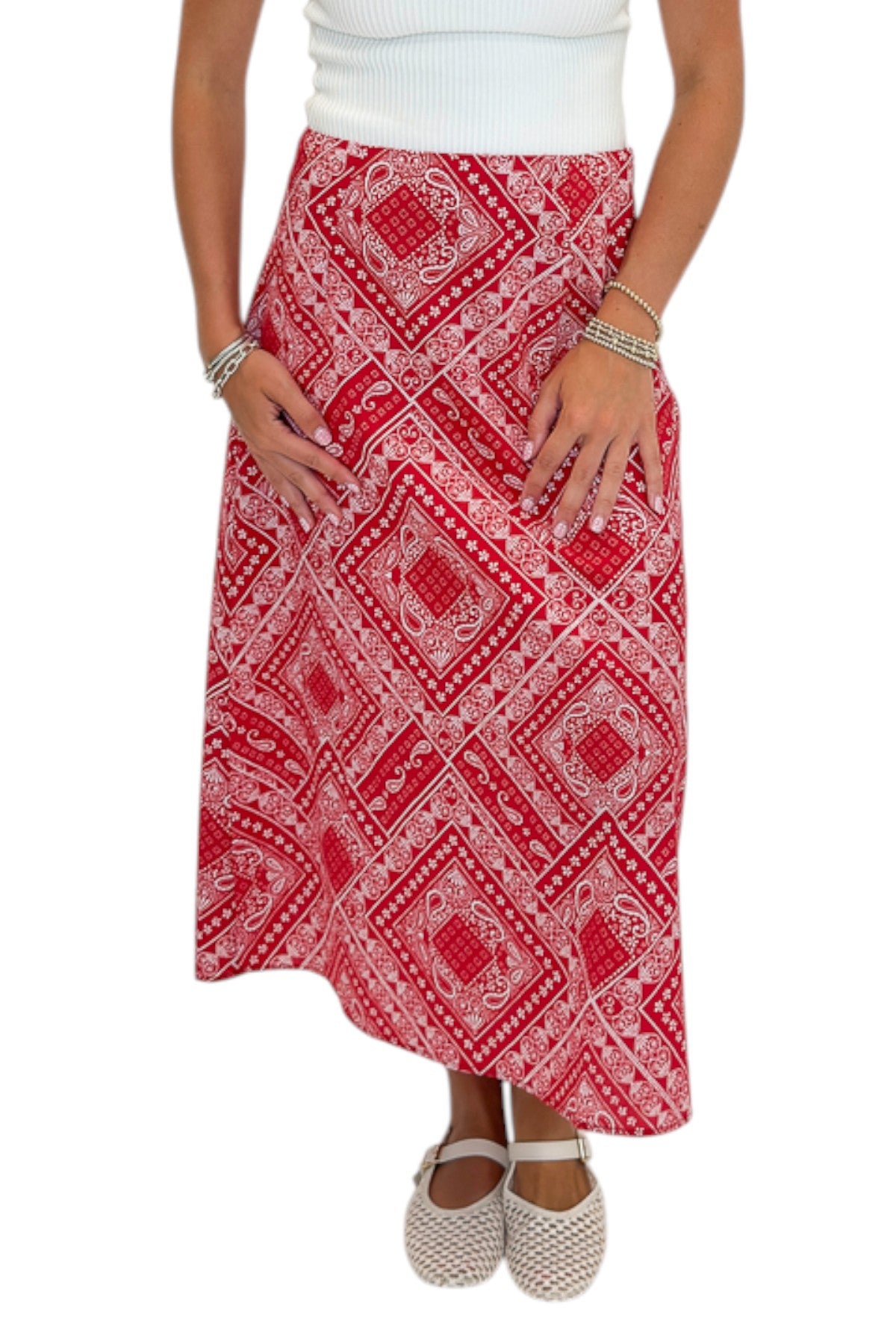 Front detail view of woman wearing Swagger Boutique’s Red Bandana Print Midi Skirt with white top against white studio background.