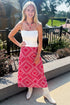 Front view of woman wearing Swagger Boutique’s Red Bandana Print Midi Skirt with white top standing outside at a park.