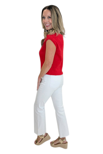 Side view of woman wearing Swagger Boutique’s Red Cap Sleeve Sweater with jeans against white studio background.