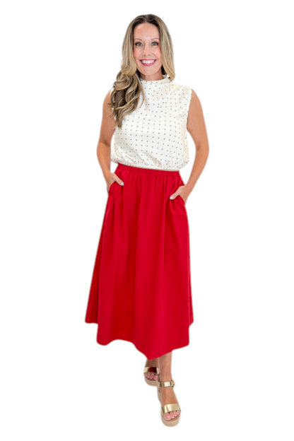 Front view of woman wearing Swagger Boutique’s Red Elastic Waist Midi Skirt with sandals against white studio background.