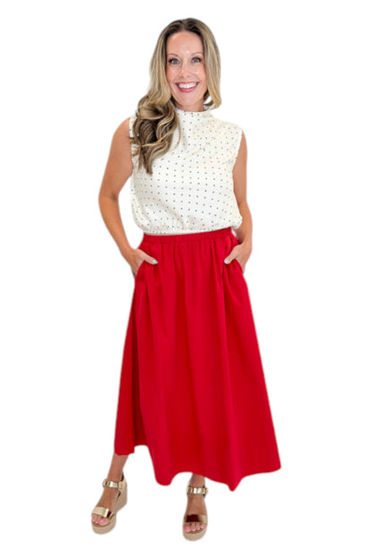 Front view of woman wearing Swagger Boutique’s Red Elastic Waist Midi Skirt with sandals against white studio background.