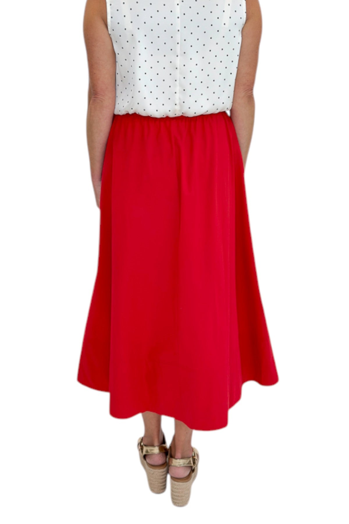 Back view of woman wearing Swagger Boutique’s Red Elastic Waist Midi Skirt with sandals against white studio background.