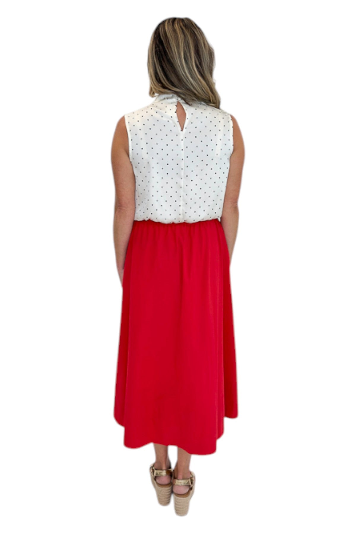 Back view of woman wearing Swagger Boutique’s Red Elastic Waist Midi Skirt with sandals against white studio background.