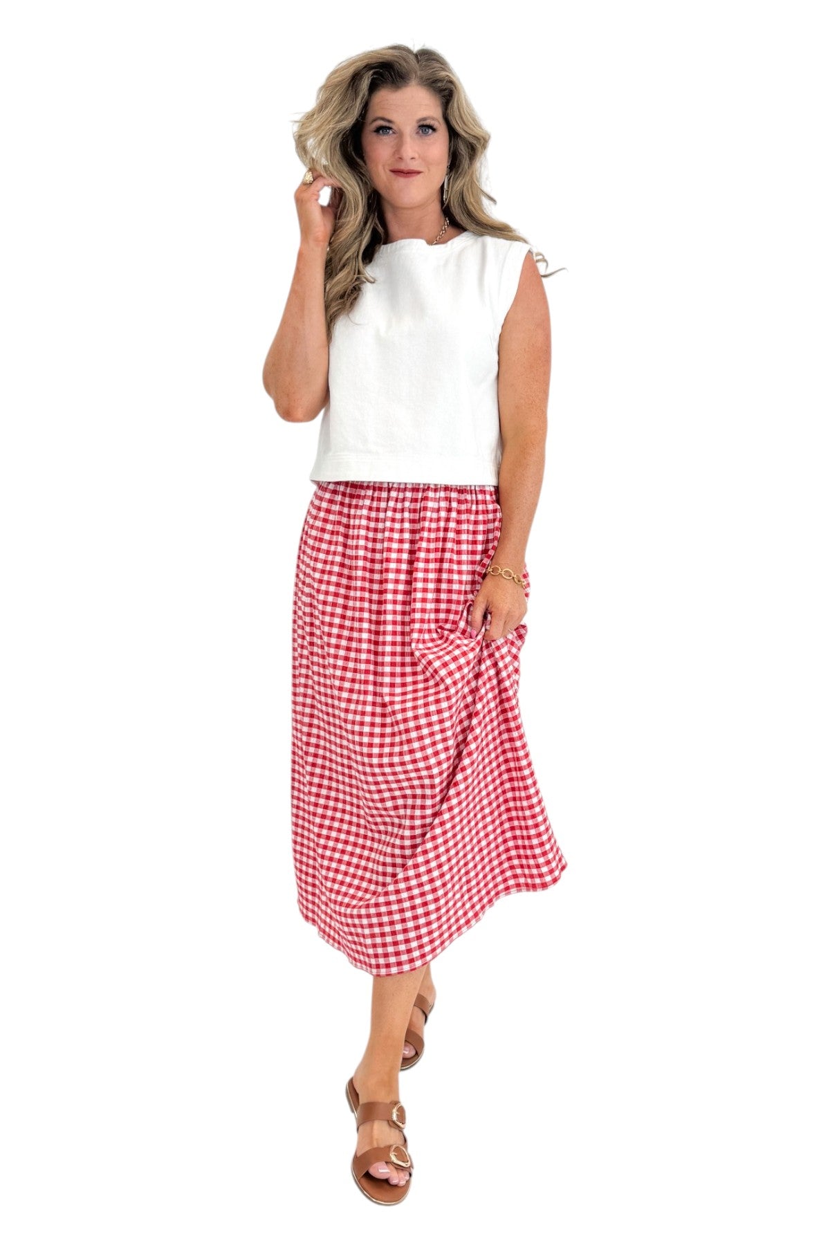 Front view of woman wearing Swagger Boutique’s Red Gingham Flowy Midi Skirt with White Denim Tank against white studio background.