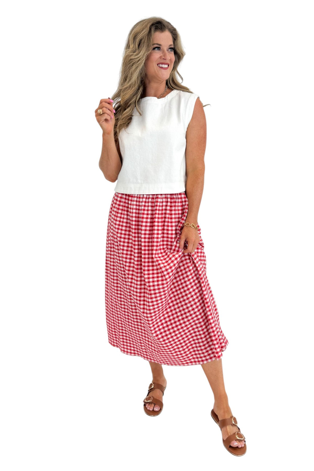 Front view of woman wearing Swagger Boutique’s Red Gingham Flowy Midi Skirt with White Denim Tank against white studio background.