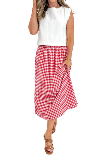 Front view of woman wearing Swagger Boutique’s Red Gingham Flowy Midi Skirt with White Denim Tank against white studio background.