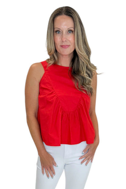 Front view of woman wearing Swagger Boutique’s Red Ruffle Tank with jeans against white studio background.