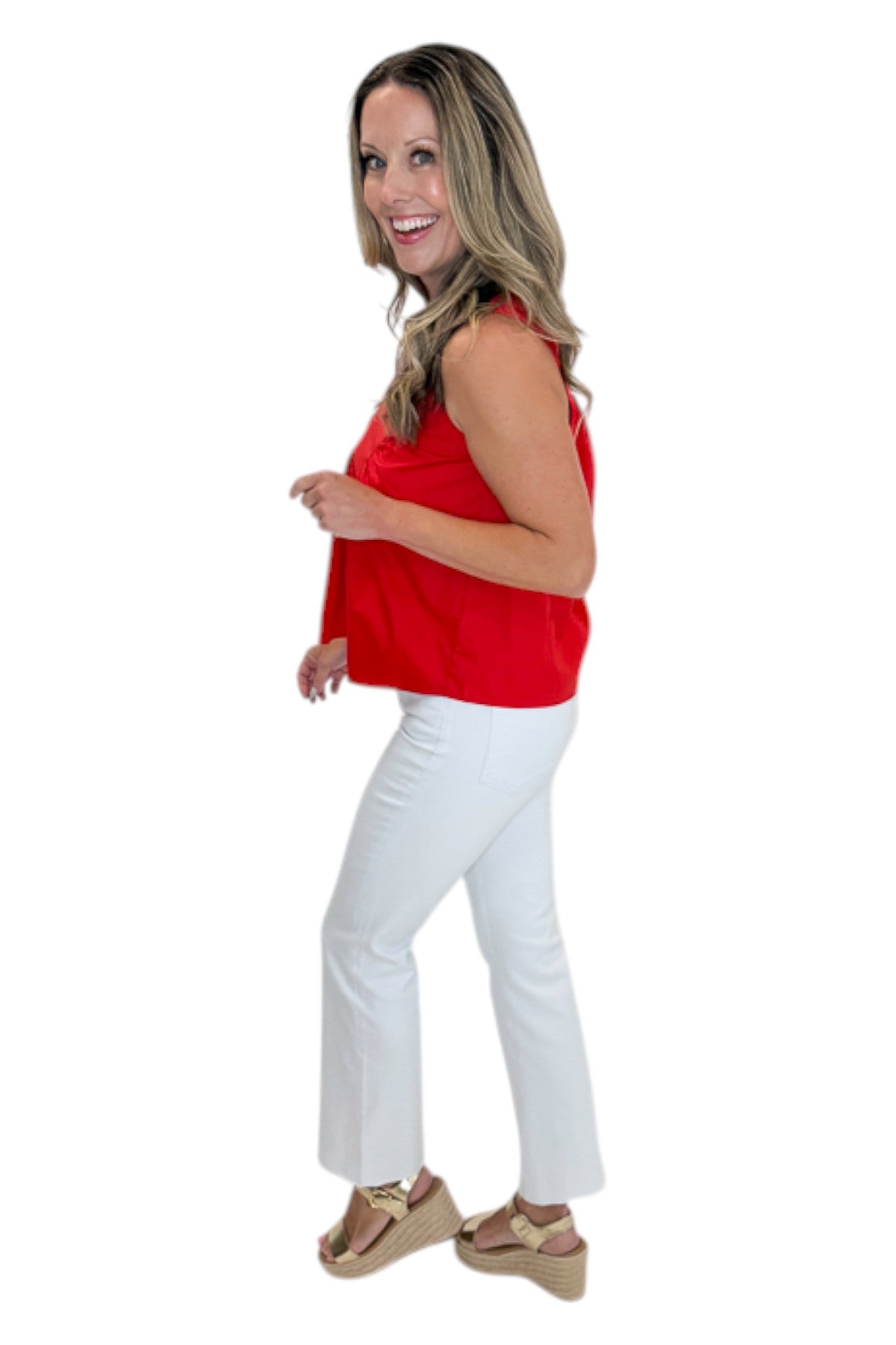 Side view of woman wearing Swagger Boutique’s Red Ruffle Tank with jeans against white studio background.