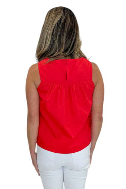 Back view of woman wearing Swagger Boutique’s Red Ruffle Tank with jeans against white studio background.
