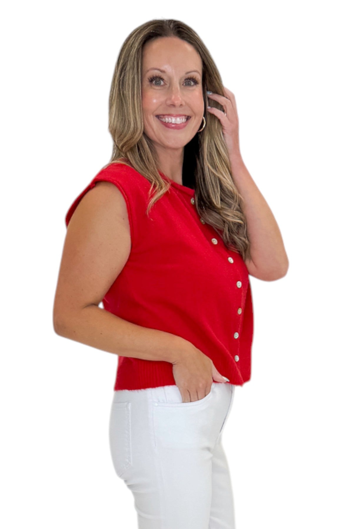 Side view of woman wearing Swagger Boutique’s Red Sleeveless Button Up Sweater with jeans against white studio background.