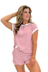 Front view of woman wearing Swagger Boutique’s Red Striped Relaxed Fit Top with red striped shorts against white studio background.