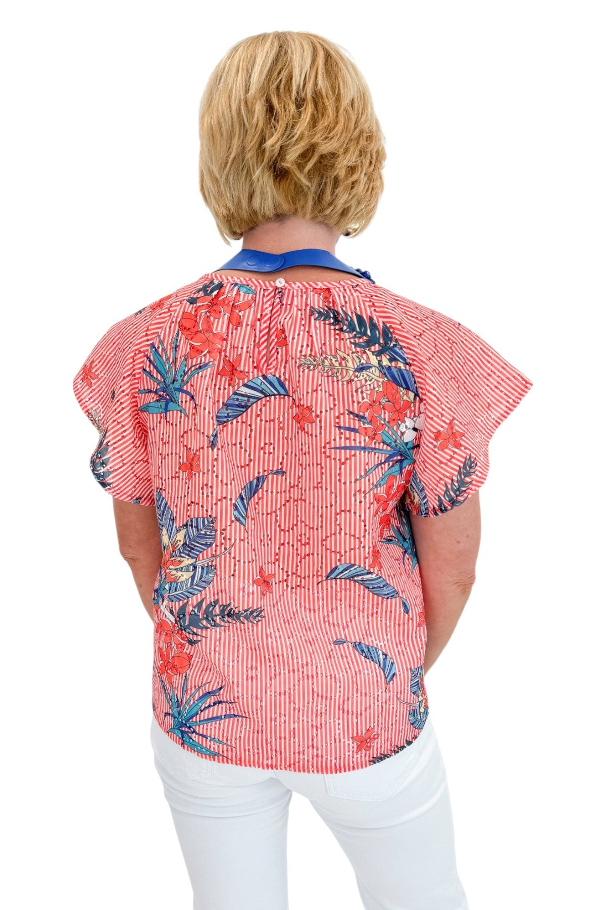 Back view of woman wearing Swagger Boutique’s Red Striped &amp; Floral Short Sleeve Top with jeans against white studio background.
