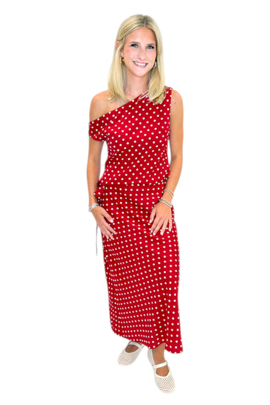 Front view of woman wearing Swagger Boutique’s Red &amp; White Polka Dot Midi Skirt with Red &amp; White Polka Dot Asymmetrical Tank against white studio background.