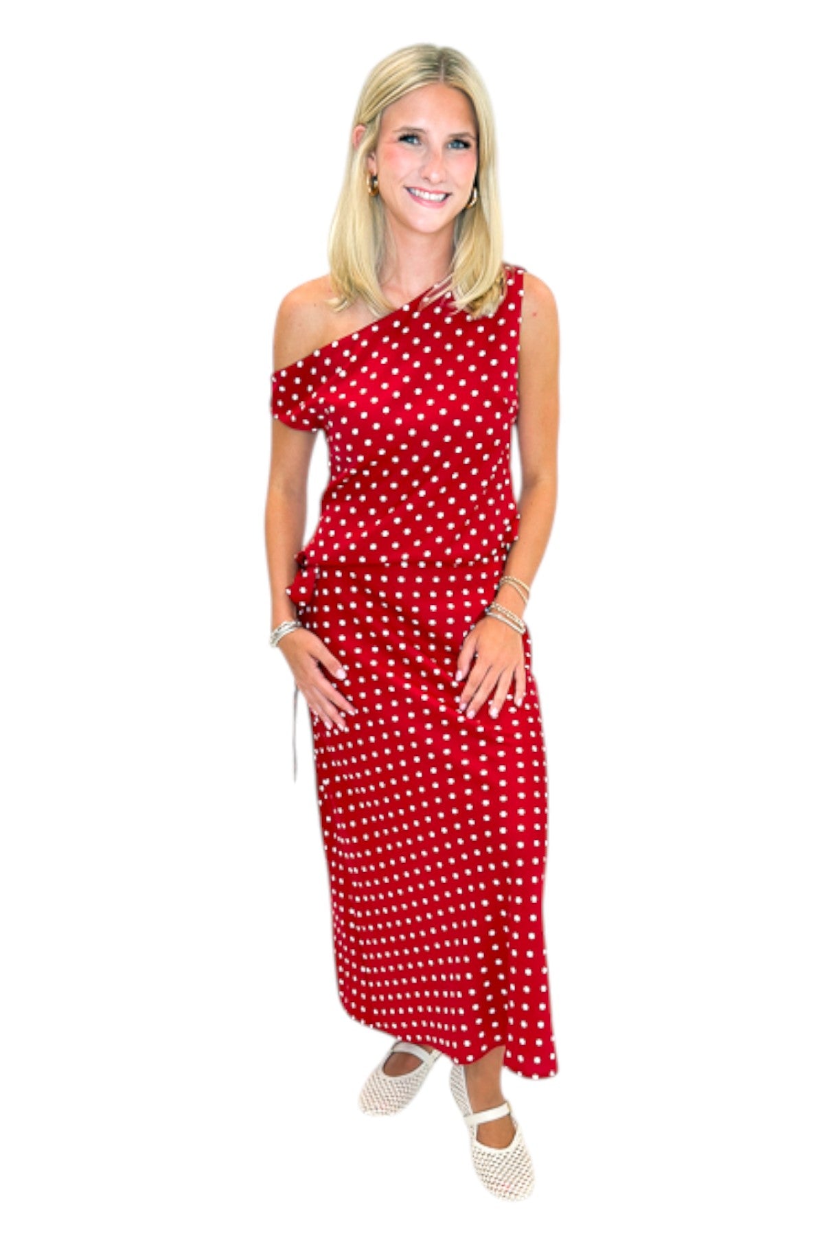 Front view of woman wearing Swagger Boutique’s Red &amp; White Polka Dot Midi Skirt with Red &amp; White Polka Dot Asymmetrical Tank against white studio background.