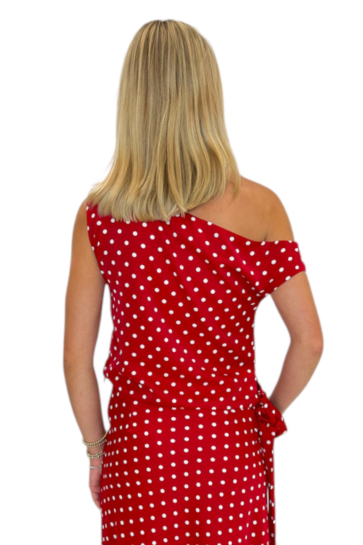 Back view of woman wearing Swagger Boutique’s Red &amp; White Polka Dot Midi Skirt with Red &amp; White Polka Dot Asymmetrical Tank against white studio background.