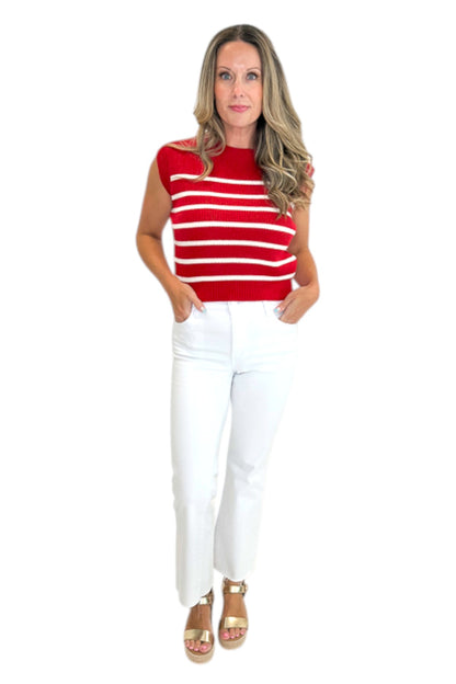 Front view of woman wearing Swagger Boutique’s Red &amp; White Striped Sleeveless Sweater with jeans against white studio background.