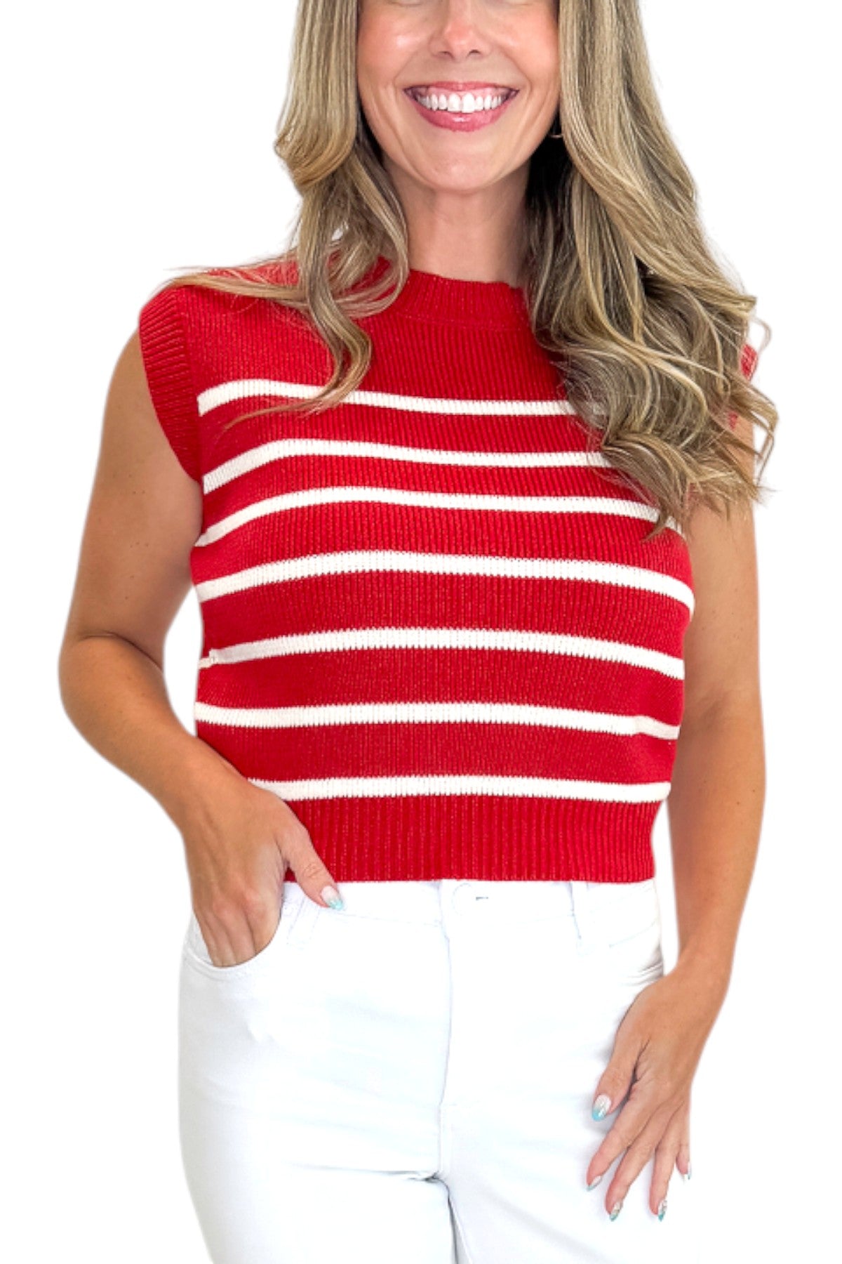 Front detail view of woman wearing Swagger Boutique’s Red &amp; White Striped Sleeveless Sweater with jeans against white studio background.