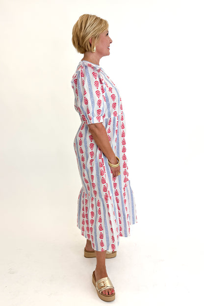 Side view of woman wearing Swagger Boutique’s Red, White &amp; Blue Jonah Midi Dress by MudPie with Lulah Platform Sandals against white studio background.