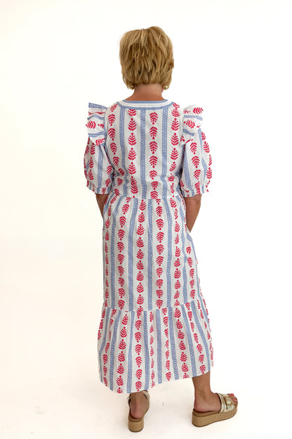 Back view of woman wearing Swagger Boutique’s Red, White &amp; Blue Jonah Midi Dress by MudPie with Lulah Platform Sandals against white studio background.