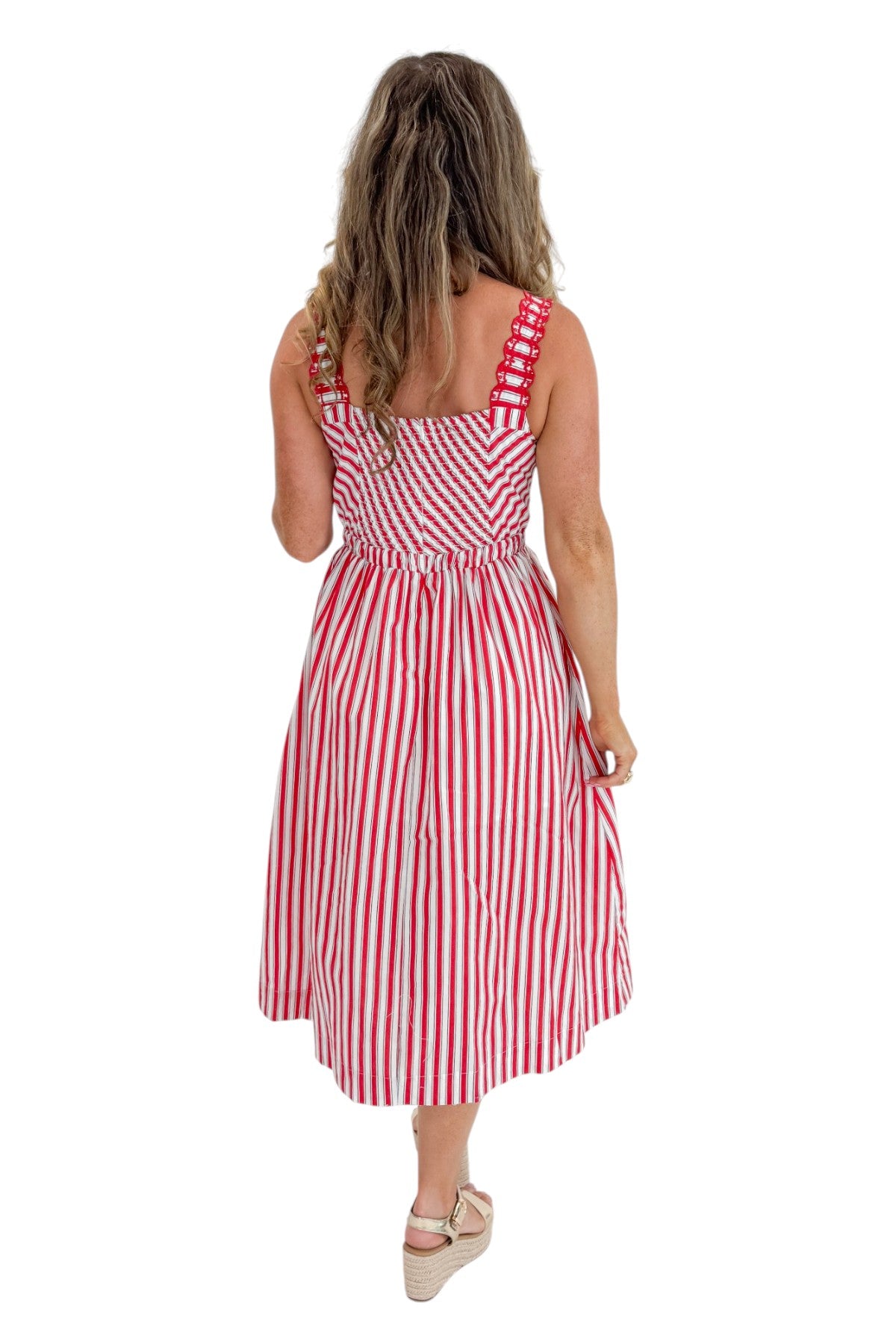 Back view of woman wearing Swagger Boutique’s Red, White &amp; Blue Striped Midi Dress with sandals against white studio background.