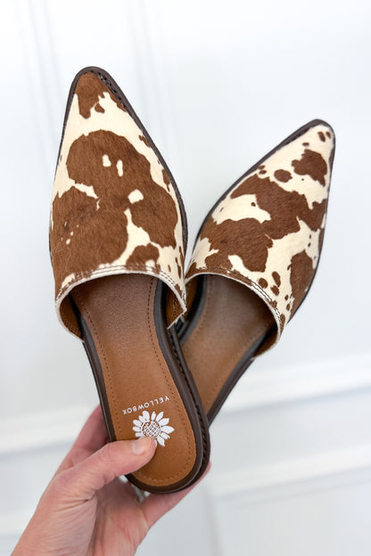 Regan- Cow Print Mule against white studio background.