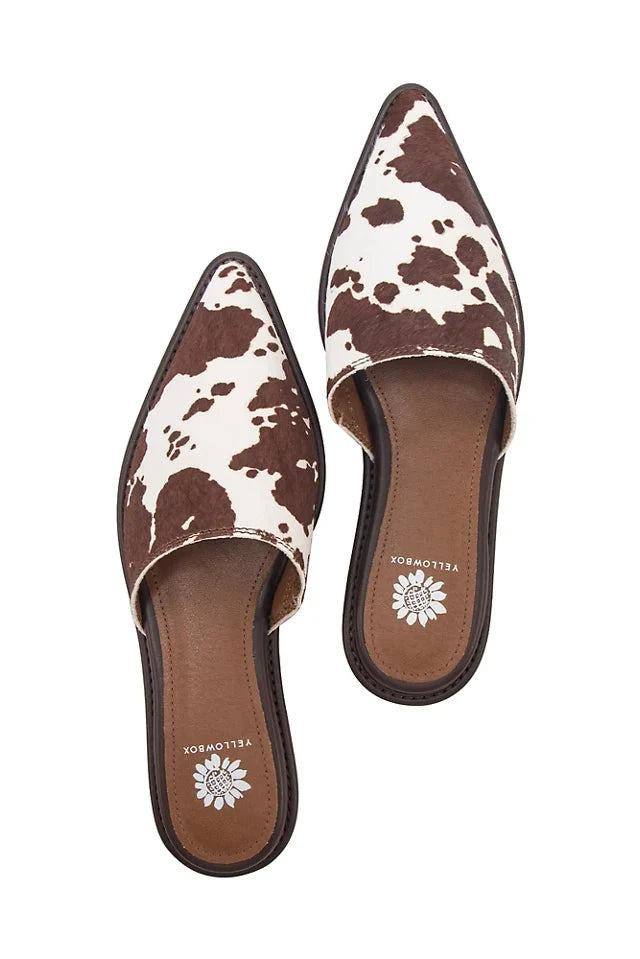 Regan- Cow Print Mule against white studio background.