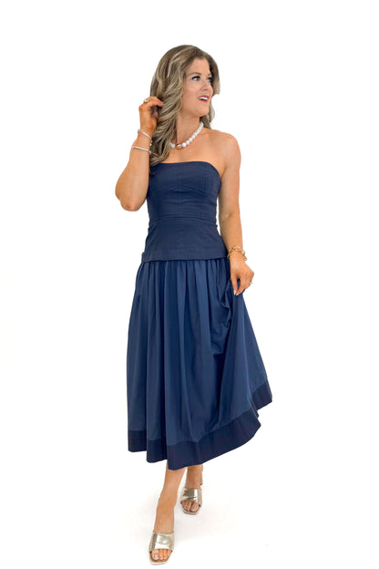 Front view of woman wearing Navy Corset Lined Midi Dress against white studio background.
