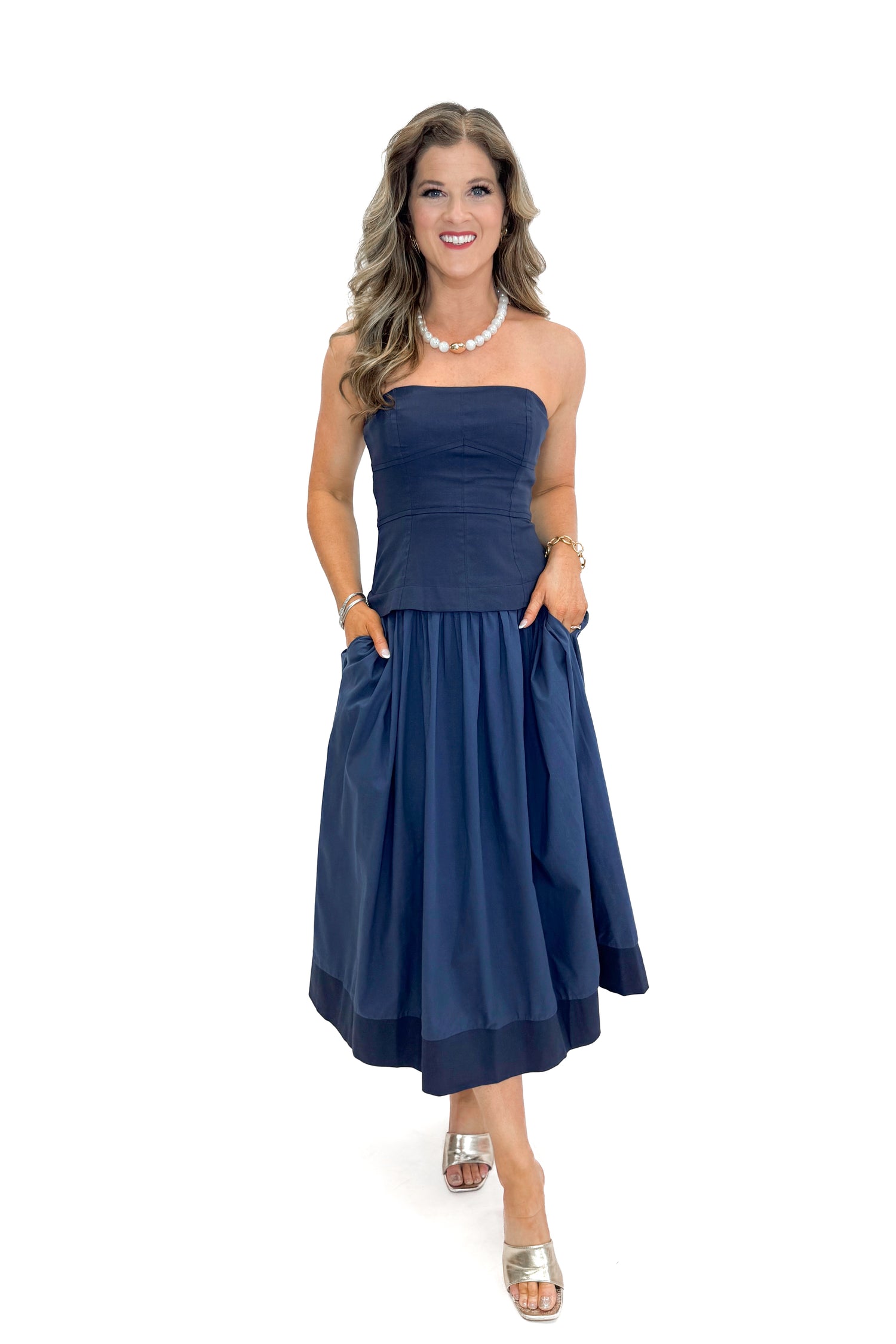 Front view of woman wearing Navy Corset Lined Midi Dress against white studio background.