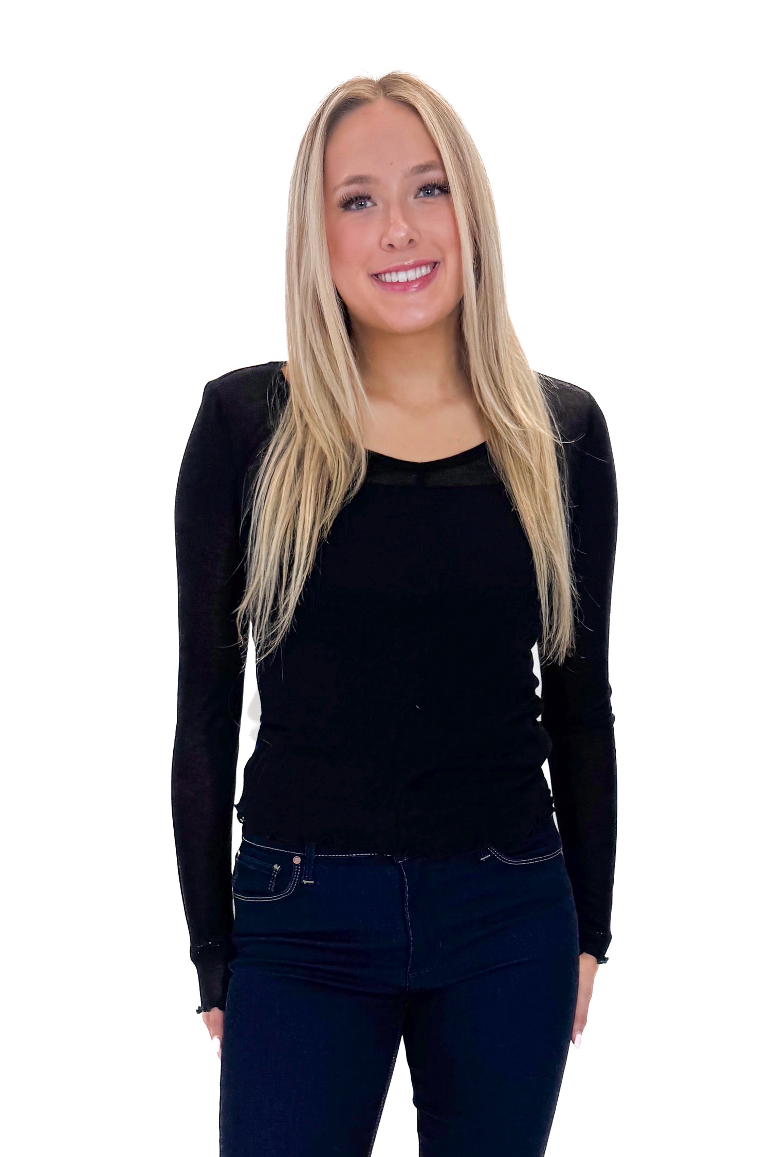 Front view of woman wearing Black Sheer Long Sleeve Top with jeans against white studio background.