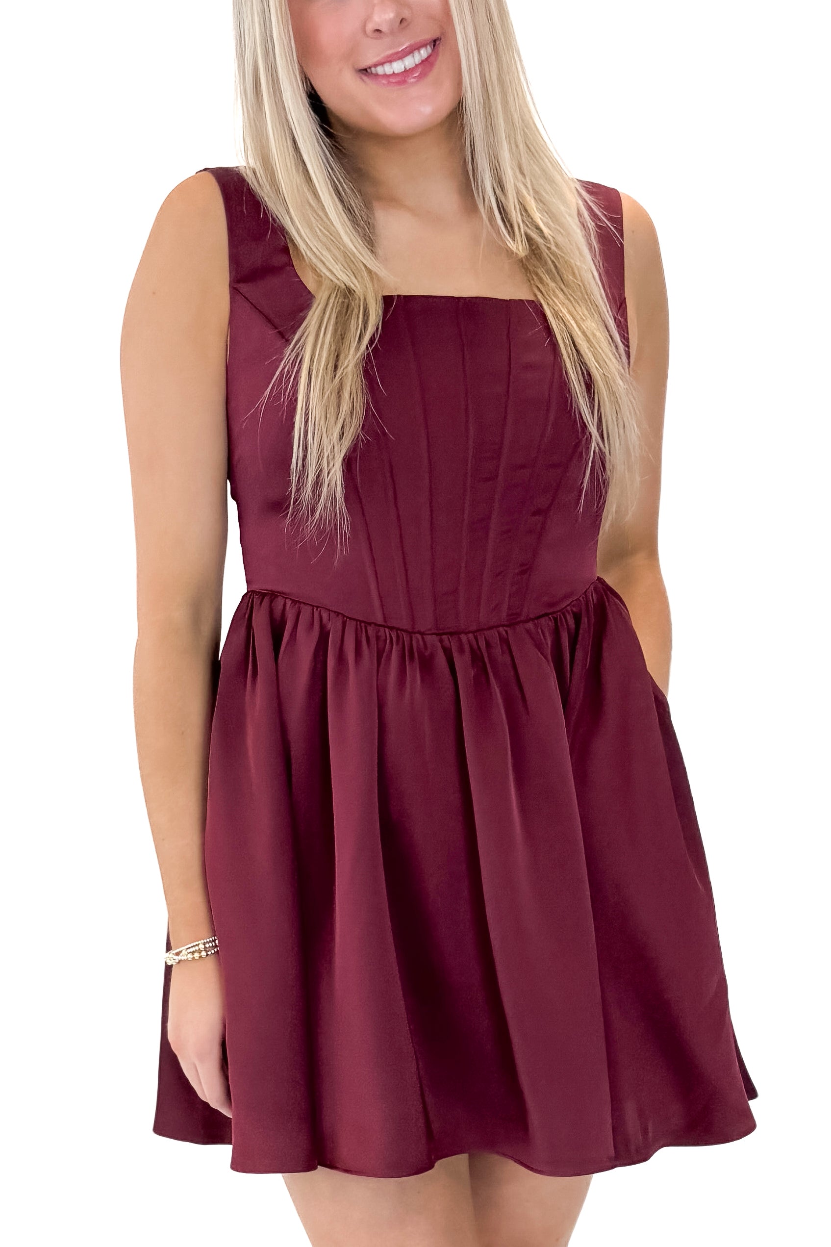 Front detailed view of woman wearing Wine Corset Detail Satin Dress with heels against white studio background.