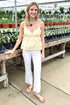 Front view of woman wearing Yellow Eyelet Tank with jeans at a garden center.